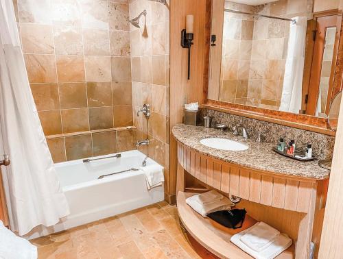 a bathroom with a tub and a sink and a bath tub at Suncadia Lodge Studio Unit in Cle Elum