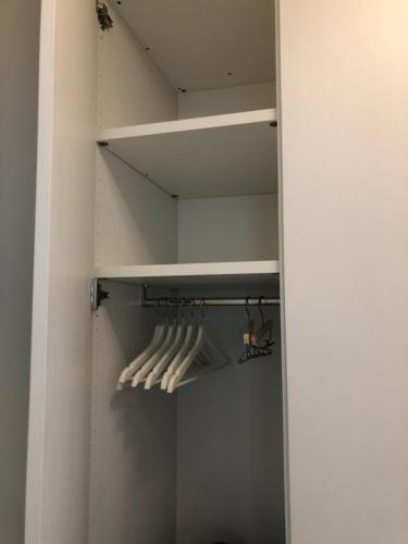 a walk in closet with white hangers at Residence Luxury Elisabeth con garage in Caorle