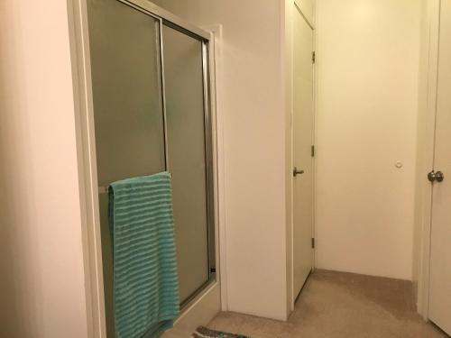 a closet with a glass door with a blue towel at Amazing Views near Grand Canyon Skywalk in Meadview