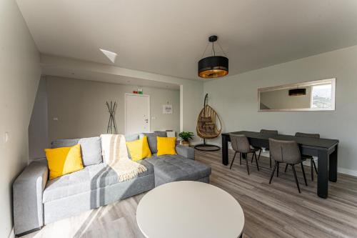 a living room with a couch and a table at Penthouse Formosa Sunset and Beach in Funchal