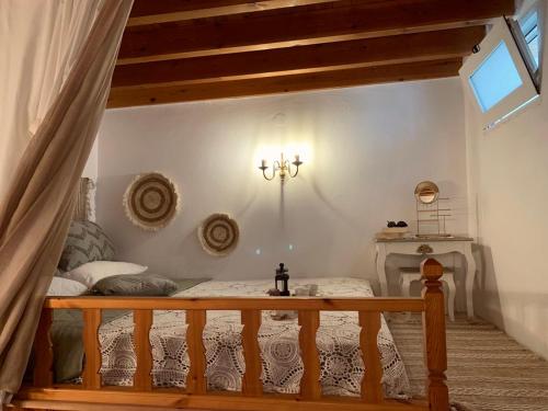 a bedroom with a bed and a table in a room at Rustic House Archangelos in Archangelos