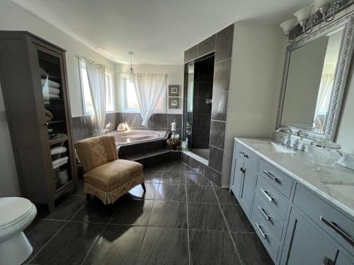 a bathroom with a tub and a toilet and a sink at Lulu's Bed & Breakfast in Niagara-on-the-Lake