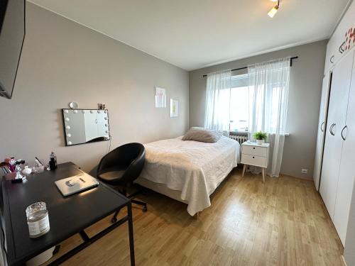a bedroom with a bed and a desk and a table at Cosy apartment centrally located in Reykjavik in Reykjavík