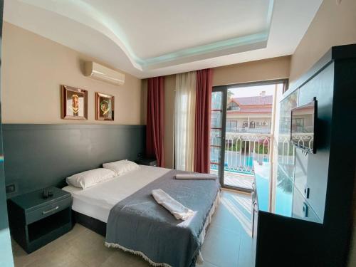 Postel nebo postele na pokoji v ubytování Ölüdeniz 1+1 Modern SummerHouse Wıth Swımmıng Pool