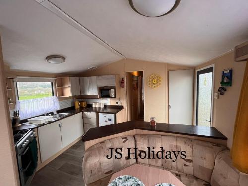 a kitchen with a us holidays sign in the middle at JS Holidays The Westmorland Lagganhouse in Ballantrae