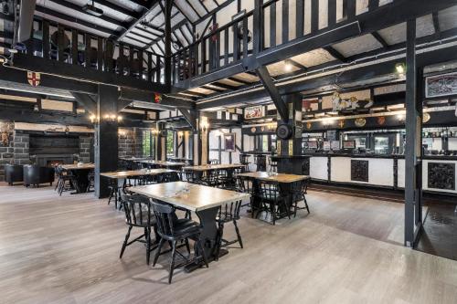 a restaurant with tables and chairs in a room at The Fox and Hounds Historic Hotel in Port Arthur