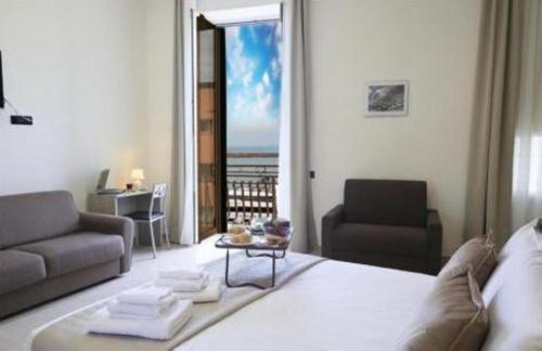 a living room with a couch and a table at AM suite Stabiae in Castellammare di Stabia
