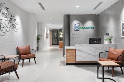 an office lobby with chairs and a reception desk at Bi Eco Suites Hanoi in Hanoi