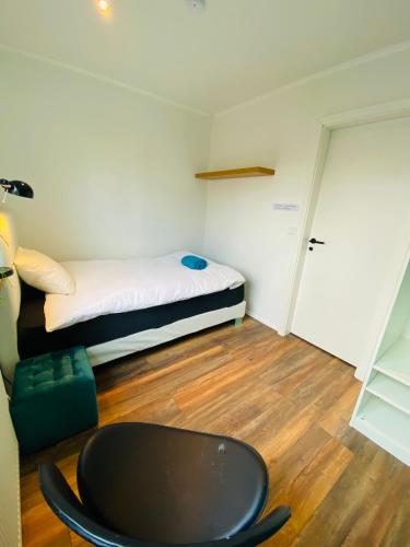 a small room with a bed and a table at Easy Stay in Keflavík