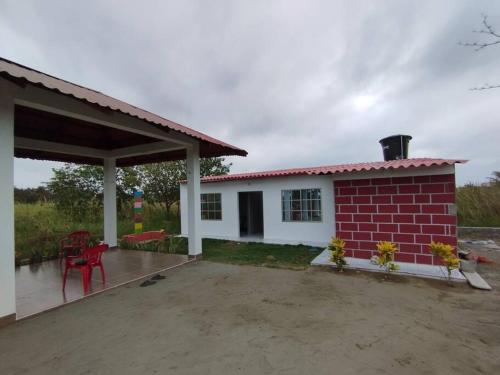 a small house with a red and white at Cabaña Isabella in San Bernardo del Viento