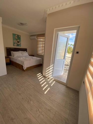 a bedroom with a bed and a sliding glass door at Villa Maleyna in Kemer