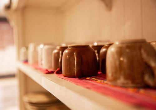 a row of brown pots sitting on a shelf at Hotel Casa Pereyra in Oaxaca City