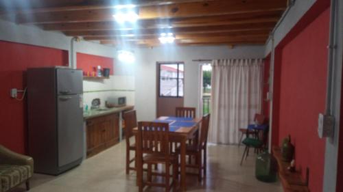 a kitchen with a table and chairs and a refrigerator at Lo de la Abuela in Goya