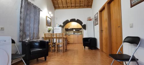 a kitchen with a table and chairs in a room at Marina de São Mateus in Angra do Heroísmo