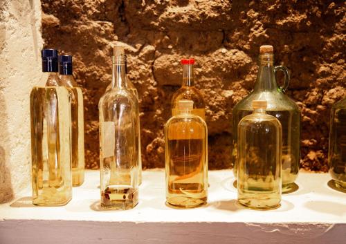 a group of wine bottles sitting on a shelf at Hotel Casa Pereyra in Oaxaca City