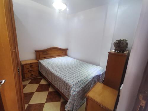 a small bedroom with a bed and a dresser at Cascadas al Onsar Chefchauen in Chefchaouen