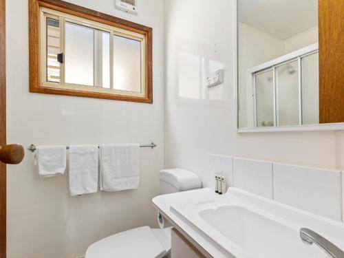 a bathroom with a sink and a toilet and a mirror at Ingenia Holidays Torquay Australia in Torquay