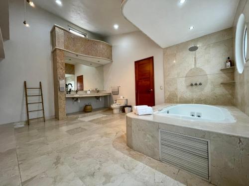 a large bathroom with a tub and a sink at Guerrero 318 in Puerto Vallarta