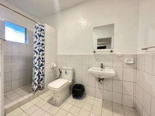 a bathroom with a toilet and a sink at CafeMare Rooms in Bantayan Island
