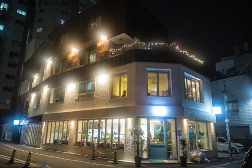 a building on a city street at night at Bluehum Guest house in Incheon