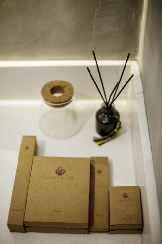 two boxes sitting on a counter with a vase at Burgos Reef Boutique Resort in Padre Burgos