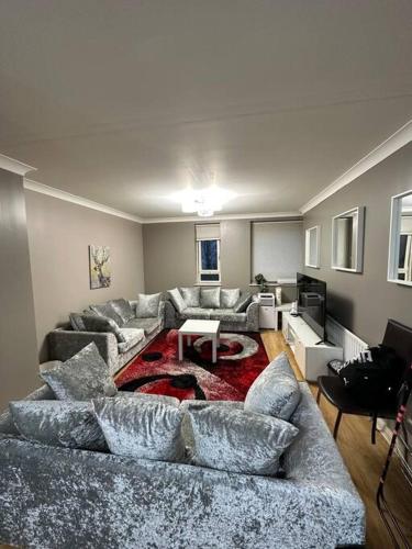 a living room with a large couch and a table at A 2 standard bedrooms flat in London