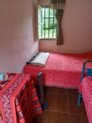a room with two beds and a window at Las Horquetas casa de campo in Yala