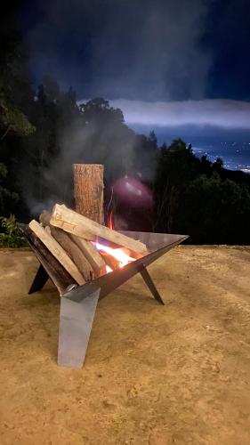 a bench with a fire on it in the dirt at Tiny Houses Premium - Casa Barcelona in Duitama