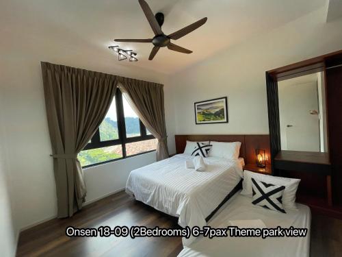 a bedroom with a bed and a ceiling fan at Ipoh Sunway Onsen Suites and Tambun Guesthouse , 3-14pax 2parking by IWH in Ipoh