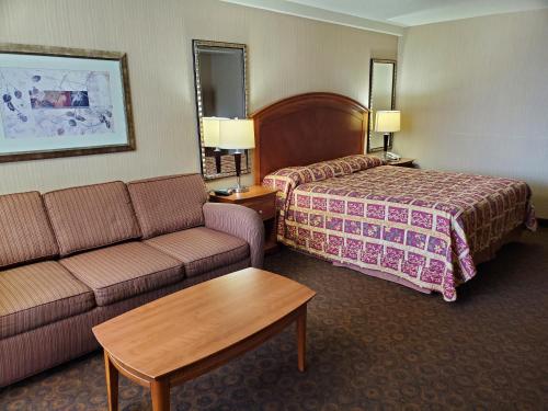 a hotel room with a bed and a couch at Royal Pacific Motor Inn in San Francisco