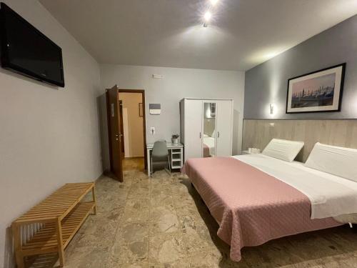 a bedroom with a large bed and a television at 216 Venice in Mestre