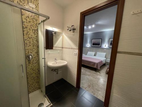 a bathroom with a sink and a shower and a bed at 216 Venice in Mestre