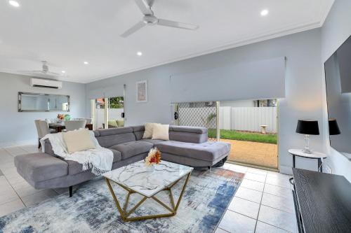 a living room with a couch and a table at The OC Home: Centrally Located, Home Away Home in Nightcliff