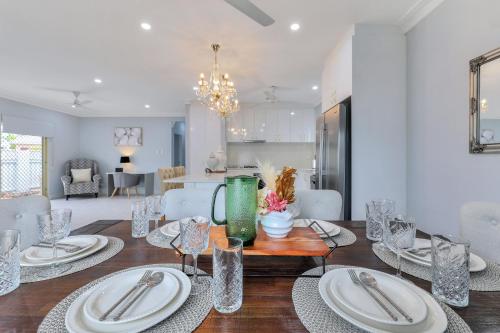 a dining room with a table with plates and silverware at The OC Home: Centrally Located, Home Away Home in Nightcliff