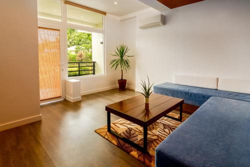 a living room with a couch and a table at Amor Laut in Mabini