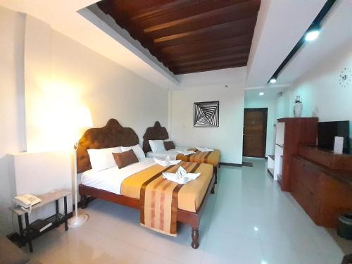 a hotel room with two beds and a television at MelSol Hotel in Bantay