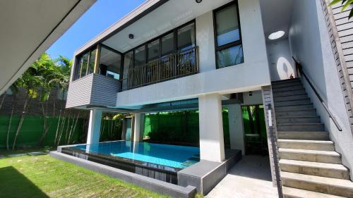 a house with a swimming pool in front of it at Fu Wan Cafe Villa in Donggang