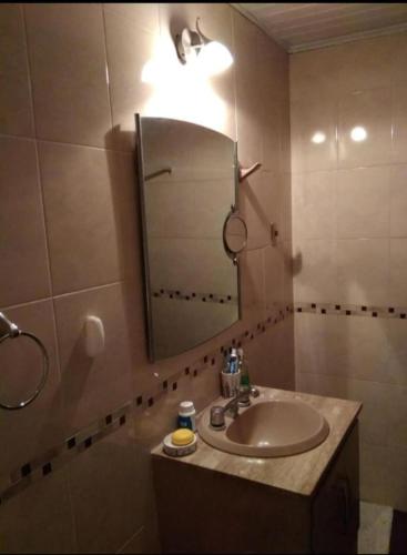 a bathroom with a sink and a mirror at El Patio de la Morocha in Montevideo