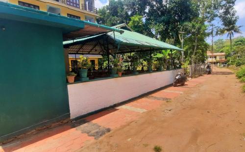 a building with a flower shop on the side of a street at Aditi in Thekkady