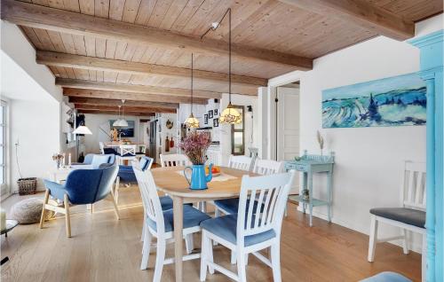 a dining room with a wooden table and chairs at Gorgeous Home In Glesborg With Wifi in Glesborg