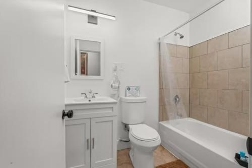 a bathroom with a toilet and a sink and a shower at Cozy&Chic Apartments Near Downtown in Philadelphia