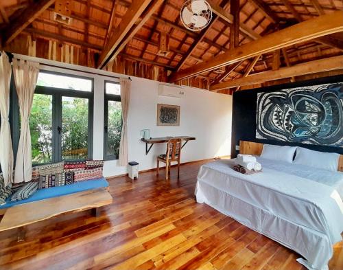 a bedroom with a bed and a desk in it at Eco Lagoon in Phu Quoc
