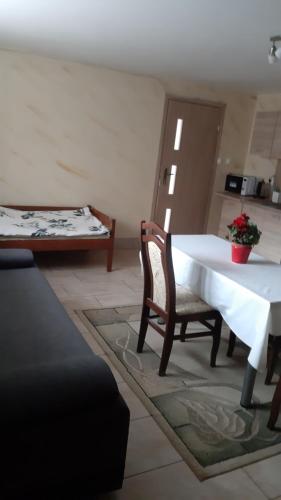 a living room with a table and a couch at Świętokrzyski Zakątek Porąbki 111a 26-004 Bieliny in Bieliny