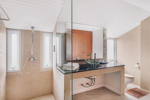 a bathroom with a sink and a shower at The Dale Pattaya Boutique and Spa in Pattaya South