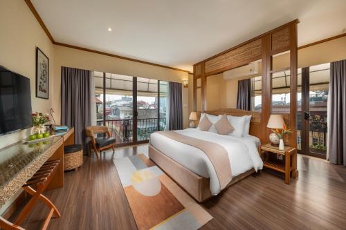 a bedroom with a large bed and a balcony at MK Premier Boutique Hotel in Hanoi