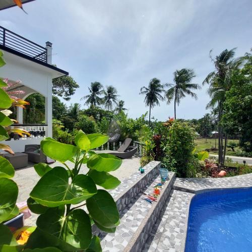 a view of the pool and the backyard of a villa at Matteo's hus VILLA RENTAL in Zamboanguita