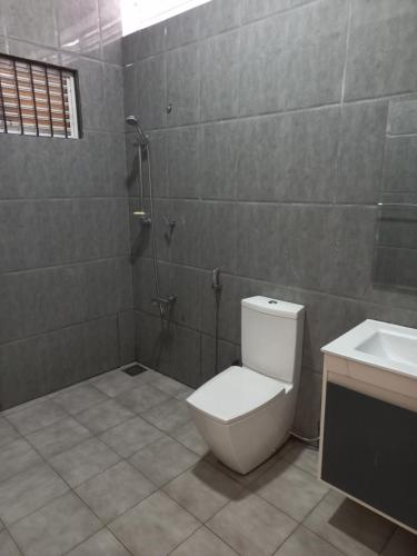 a bathroom with a toilet and a sink at The Anchorage Villa - Negombo in Negombo