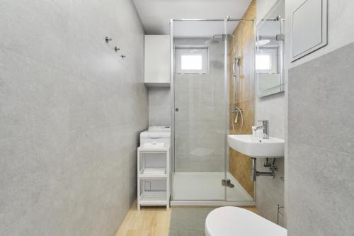 a bathroom with a shower and a sink and a toilet at Charming Family Apartment in Wroclaw by Renters in Wrocław