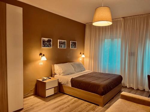 a bedroom with a bed and a table and a window at Albergo Ristorante Belsito in Fiuggi