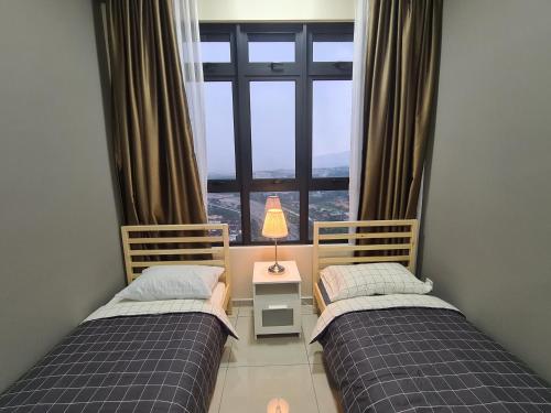 two beds in a room with a window at Alpine Parkland Netflix 5 beds at MRT Batu 11 Cheras in Cheras
